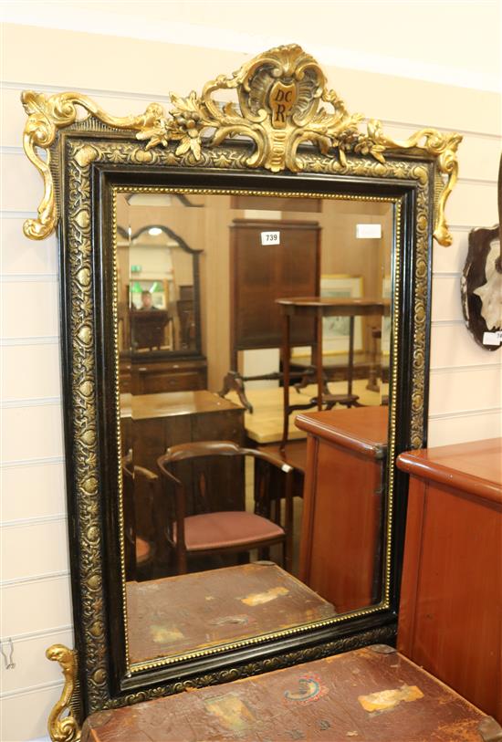 An ebonised and gilt wall mirror, W.85cm